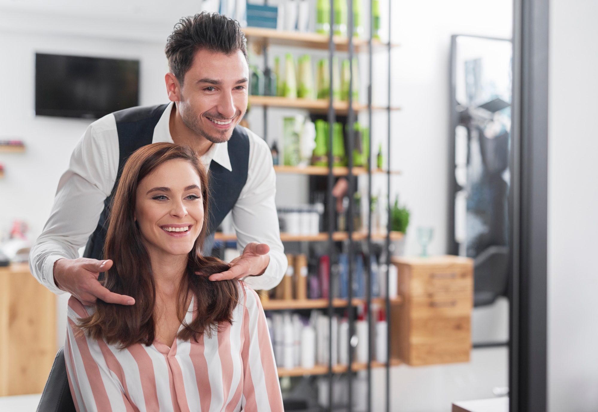 hairstylist and female customer in hair salon